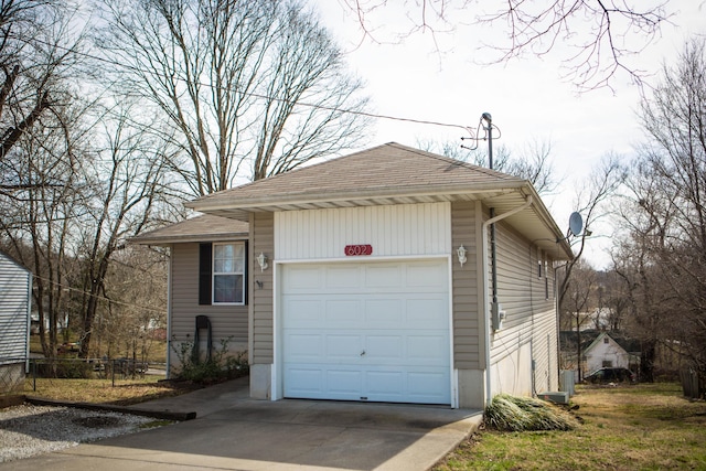 602 E Robertson, Ozark, MO 65721 - view of front facade with driveway, a garage, and a shingled roof
