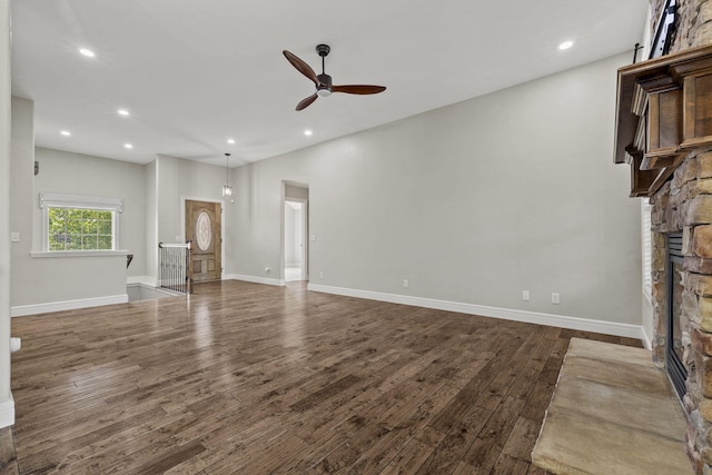 5323 S Carson St, Battlefield, MO 65619 - unfurnished living room with a stone fireplace, ceiling fan, dark wood-style floors, and recessed lighting