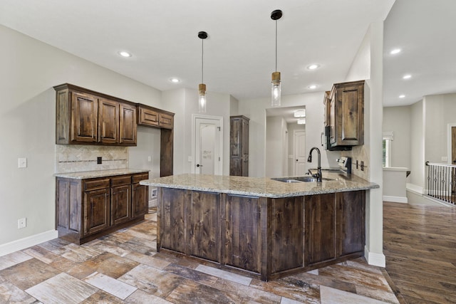 5323 S Carson St, Battlefield, MO 65619 - kitchen featuring a peninsula, light stone countertops, tasteful backsplash, recessed lighting, and dark brown cabinetry