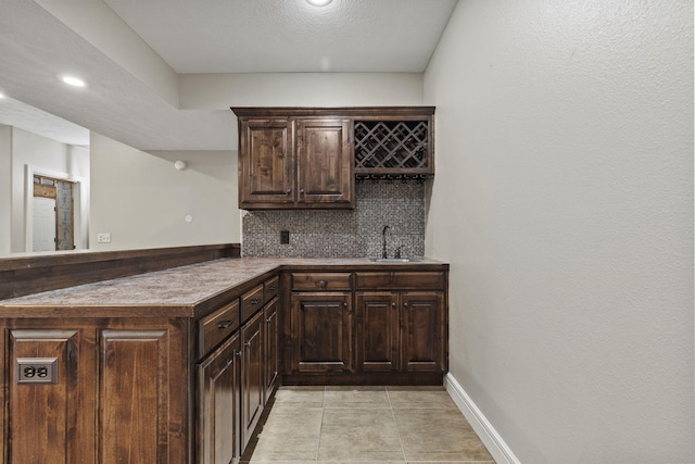 5323 S Carson St, Battlefield, MO 65619 - indoor wet bar with tasteful backsplash, light tile patterned floors, and recessed lighting