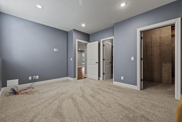 5323 S Carson St, Battlefield, MO 65619 - unfurnished bedroom with a walk in closet, carpet flooring, and recessed lighting
