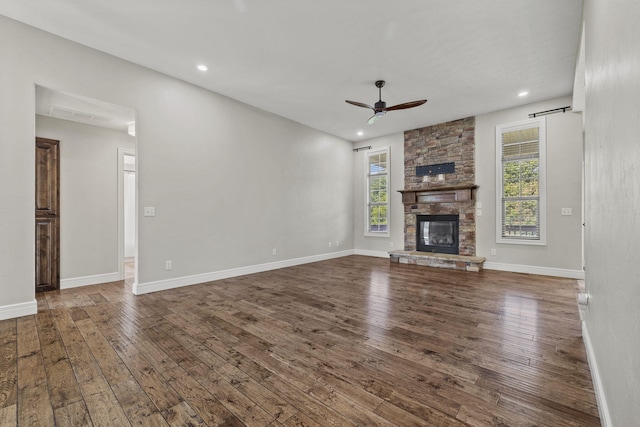 5323 S Carson St, Battlefield, MO 65619 - unfurnished living room featuring a ceiling fan, healthy amount of natural light, dark wood-style floors, a stone fireplace, and recessed lighting