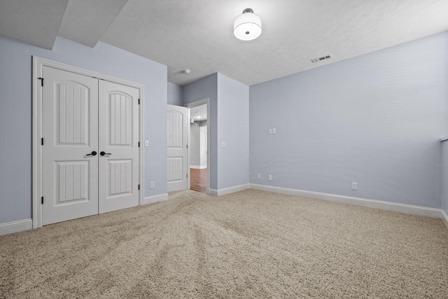 5323 S Carson St, Battlefield, MO 65619 - unfurnished bedroom with carpet floors, a closet, and a textured ceiling