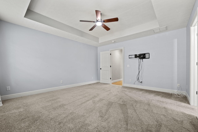 5323 S Carson St, Battlefield, MO 65619 - spare room featuring a tray ceiling, ceiling fan, and carpet