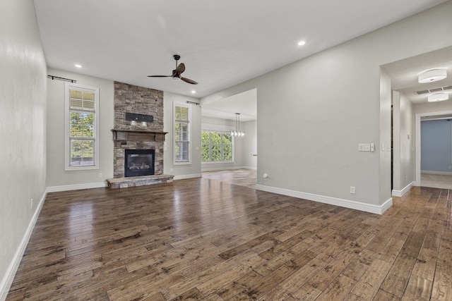 5323 S Carson St, Battlefield, MO 65619 - unfurnished living room with healthy amount of natural light, wood-type flooring, ceiling fan, a stone fireplace, and recessed lighting