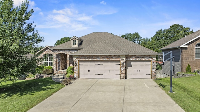 5323 S Carson St, Battlefield, MO 65619 - view of front of house with driveway, a front lawn, an attached garage, roof with shingles, and brick siding