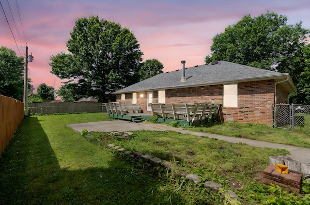 508 N Cherry Cir, Nixa, MO 65714 - yard at dusk featuring a wooden deck and a fenced backyard