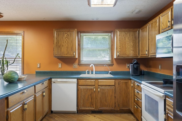 508 N Cherry Cir, Nixa, MO 65714 - kitchen featuring stainless steel appliances, healthy amount of natural light, brown cabinetry, and a textured ceiling