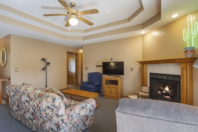 508 N Cherry Cir, Nixa, MO 65714 - living room featuring carpet, a tile fireplace, ceiling fan, a tray ceiling, and recessed lighting