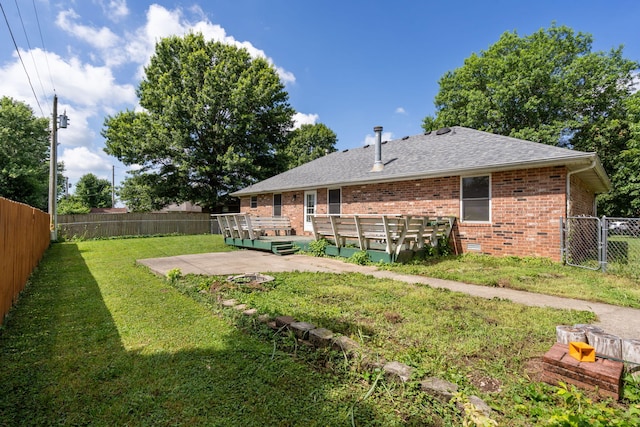 508 N Cherry Cir, Nixa, MO 65714 - back of house featuring a deck, brick siding, a fenced backyard, roof with shingles, and a gate
