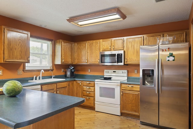 508 N Cherry Cir, Nixa, MO 65714 - kitchen with appliances with stainless steel finishes, dark countertops, light wood-style flooring, and a peninsula