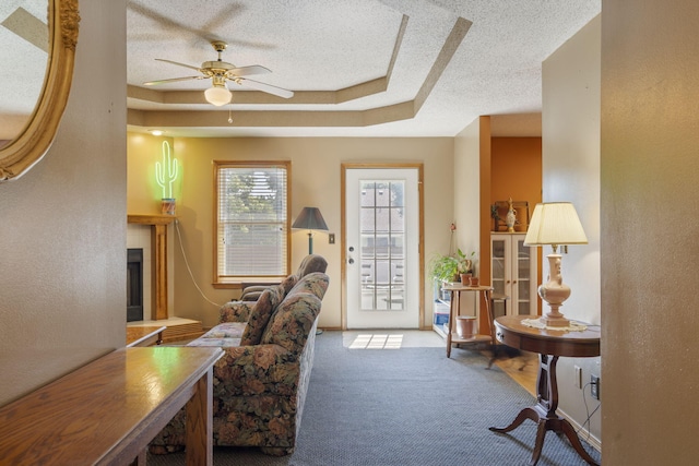 508 N Cherry Cir, Nixa, MO 65714 - home office featuring carpet, ceiling fan, a textured ceiling, a fireplace, and a raised ceiling