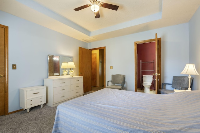 508 N Cherry Cir, Nixa, MO 65714 - carpeted bedroom with ensuite bathroom, a raised ceiling, and a ceiling fan