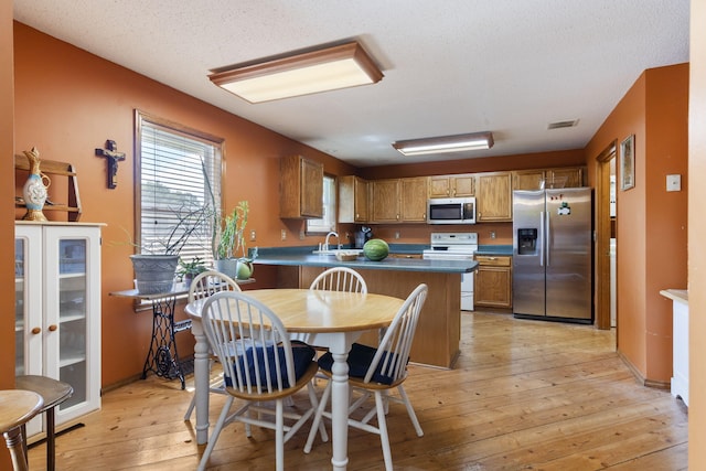 508 N Cherry Cir, Nixa, MO 65714 - dining space with light wood finished floors and a textured ceiling