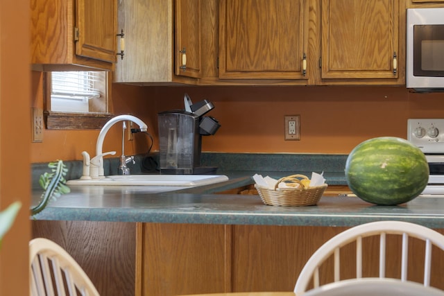 508 N Cherry Cir, Nixa, MO 65714 - kitchen featuring stainless steel microwave, brown cabinetry, and dark countertops