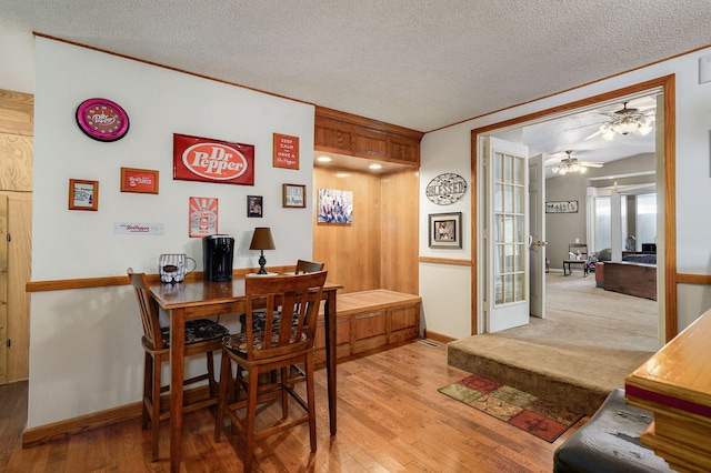 1343 Woodlawn Ave, Mount Vernon, MO 65712 - dining space with ceiling fan, light wood-type flooring, a textured ceiling, and ornamental molding