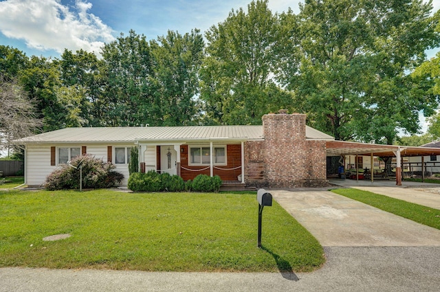1343 Woodlawn Ave, Mount Vernon, MO 65712 - ranch-style house featuring covered porch, a front yard, a chimney, a metal roof, and driveway