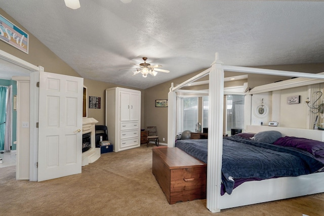 1343 Woodlawn Ave, Mount Vernon, MO 65712 - bedroom featuring vaulted ceiling, a textured ceiling, light carpet, a fireplace, and a ceiling fan
