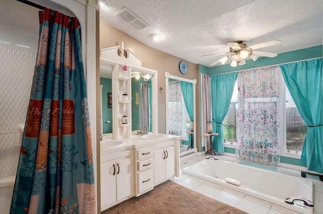 1343 Woodlawn Ave, Mount Vernon, MO 65712 - bathroom featuring a garden tub, a ceiling fan, double vanity, a textured ceiling, and tile patterned flooring