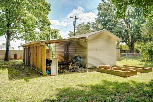 1343 Woodlawn Ave, Mount Vernon, MO 65712 - view of shed with a vegetable garden and a fenced backyard