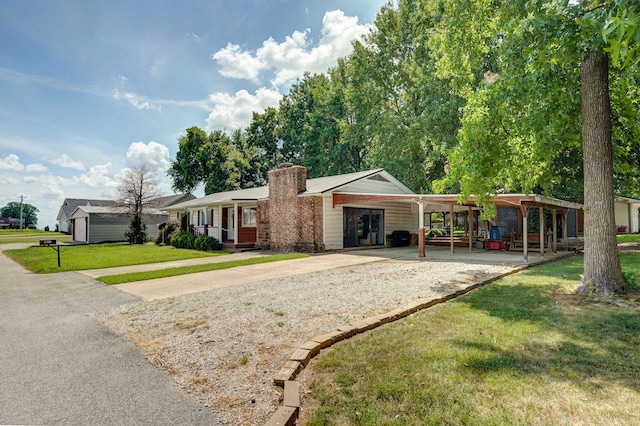 1343 Woodlawn Ave, Mount Vernon, MO 65712 - view of front of home featuring a front lawn, driveway, a chimney, and an attached carport