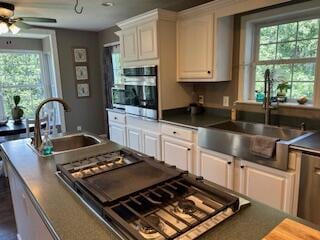 134 Meadowbrook Ln, Walnut Shade, MO 65771 - kitchen featuring stainless steel oven, dark countertops, cooktop, and white cabinetry
