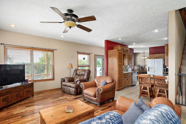 8404 Fossilsaurus Ln, Ash Grove, MO 65604 - living area featuring a ceiling fan, light wood finished floors, a textured ceiling, and recessed lighting