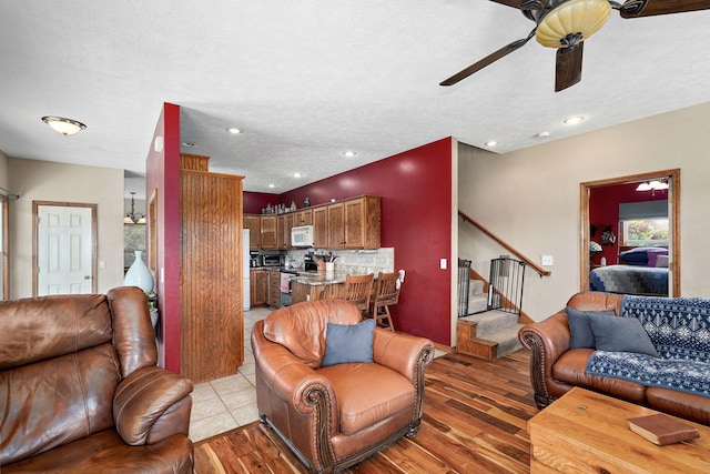 8404 Fossilsaurus Ln, Ash Grove, MO 65604 - living room with a ceiling fan, light wood finished floors, stairs, and recessed lighting