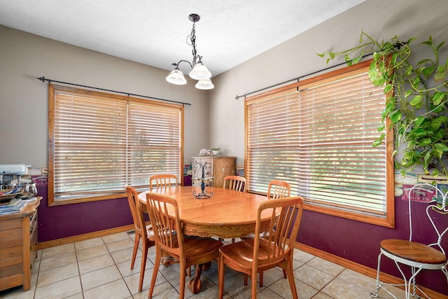 8404 Fossilsaurus Ln, Ash Grove, MO 65604 - dining room with light tile patterned floors, a chandelier, and a textured ceiling