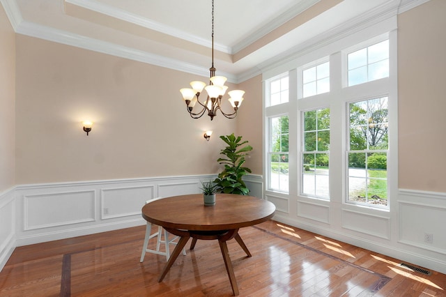 1776 S Gregg Rd, Nixa, MO 65714 - dining space featuring a chandelier, a raised ceiling, wainscoting, crown molding, and wood finished floors