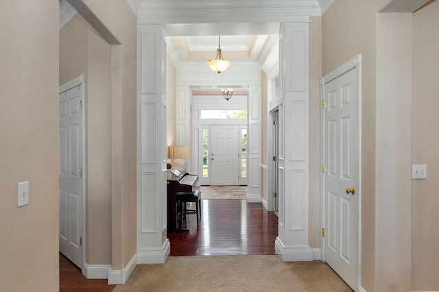 1776 S Gregg Rd, Nixa, MO 65714 - carpeted entrance foyer featuring a chandelier, crown molding, wood finished floors, decorative columns, and a raised ceiling