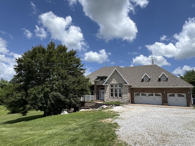 1776 S Gregg Rd, Nixa, MO 65714 - view of front facade with gravel driveway, a front yard, stone siding, a garage, and a shingled roof