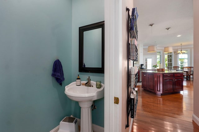1776 S Gregg Rd, Nixa, MO 65714 - bathroom featuring wood finished floors and a chandelier