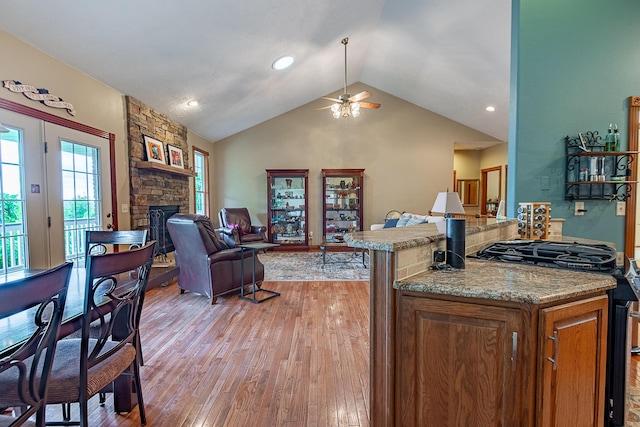 280 Center Rd, Ozark, MO 65721 - living area featuring ceiling fan, a stone fireplace, light wood-style flooring, and lofted ceiling