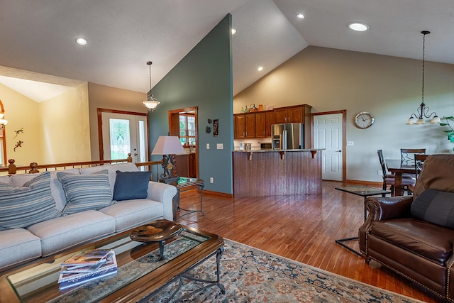 280 Center Rd, Ozark, MO 65721 - living room featuring high vaulted ceiling, wood finished floors, recessed lighting, and a chandelier