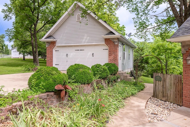 280 Center Rd, Ozark, MO 65721 - view of property exterior featuring a garage, entry steps, and brick siding