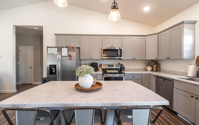 1643 Columbia Ave, Rolla, MO 65401 - kitchen featuring appliances with stainless steel finishes, gray cabinetry, a breakfast bar, pendant lighting, and dark wood-type flooring