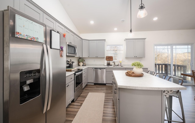 1643 Columbia Ave, Rolla, MO 65401 - kitchen with stainless steel appliances, gray cabinetry, a breakfast bar area, dark wood-style floors, and a center island