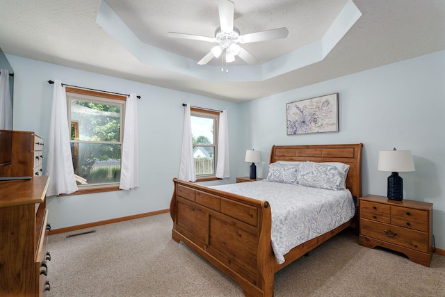 3605 N 30th St, Ozark, MO 65721 - bedroom with light carpet, multiple windows, a tray ceiling, and a ceiling fan