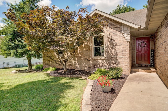 3605 N 30th St, Ozark, MO 65721 - property entrance with brick siding, a yard, and roof with shingles