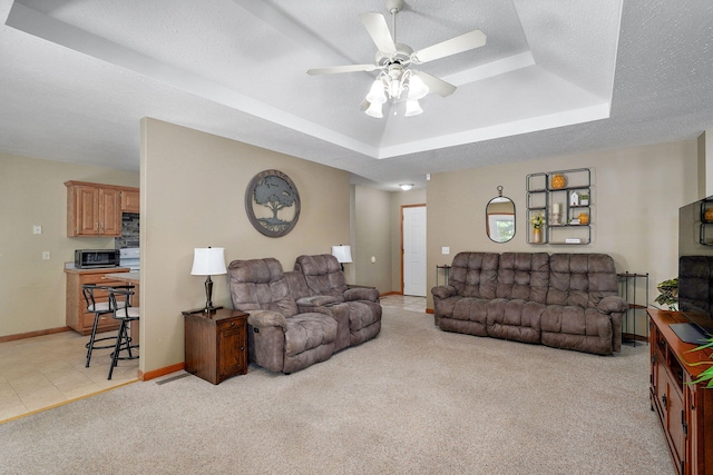 3605 N 30th St, Ozark, MO 65721 - living area with a raised ceiling, ceiling fan, and light carpet