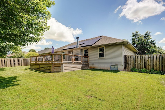 3605 N 30th St, Ozark, MO 65721 - rear view of house featuring a wooden deck, a fenced backyard, roof mounted solar panels, and a shingled roof