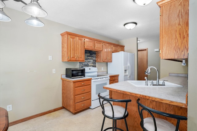 3605 N 30th St, Ozark, MO 65721 - kitchen with white appliances, light countertops, a breakfast bar, and a peninsula