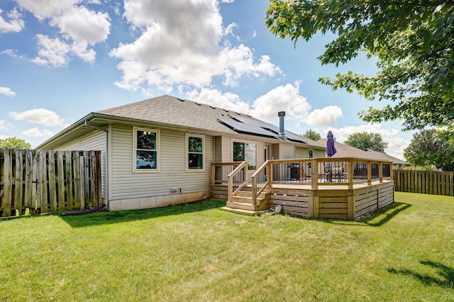 3605 N 30th St, Ozark, MO 65721 - back of property with a fenced backyard, a deck, a shingled roof, and solar panels