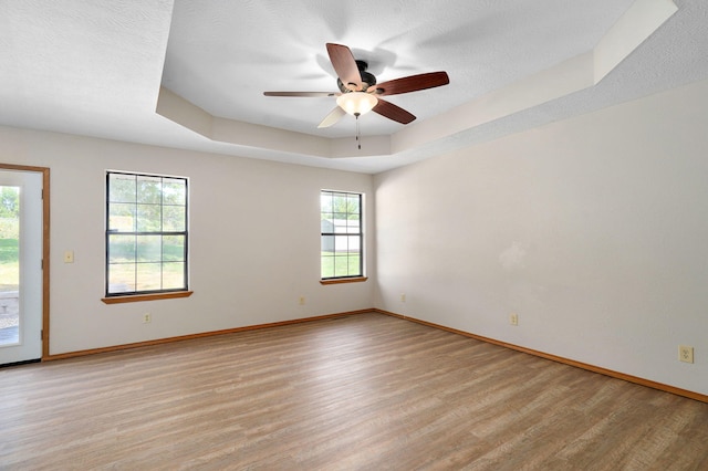 904 N 41st St, Nixa, MO 65714 - empty room featuring light wood-style floors, a ceiling fan, and a tray ceiling