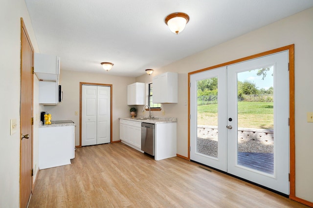 904 N 41st St, Nixa, MO 65714 - kitchen with stainless steel dishwasher, french doors, white cabinetry, light wood finished floors, and light stone counters