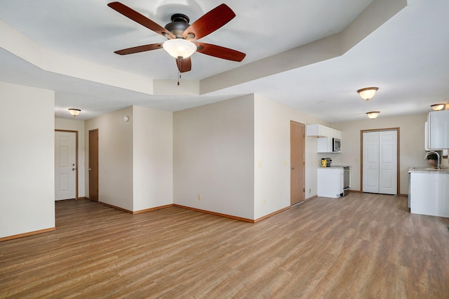 904 N 41st St, Nixa, MO 65714 - unfurnished living room with light wood-style flooring and ceiling fan