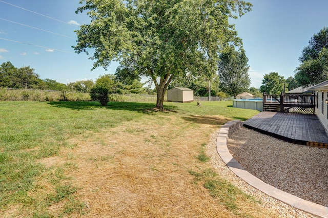 904 N 41st St, Nixa, MO 65714 - view of yard with a storage unit, a wooden deck, and an outdoor pool