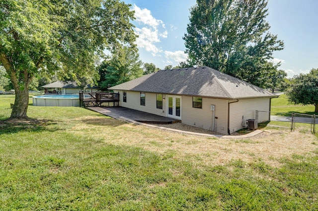 904 N 41st St, Nixa, MO 65714 - back of property featuring french doors, a wooden deck, an outdoor pool, and roof with shingles