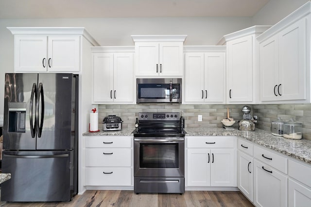 1240 E Keeling Pl, Bolivar, MO 65613 - kitchen featuring stainless steel appliances, white cabinetry, backsplash, light stone countertops, and wood finished floors